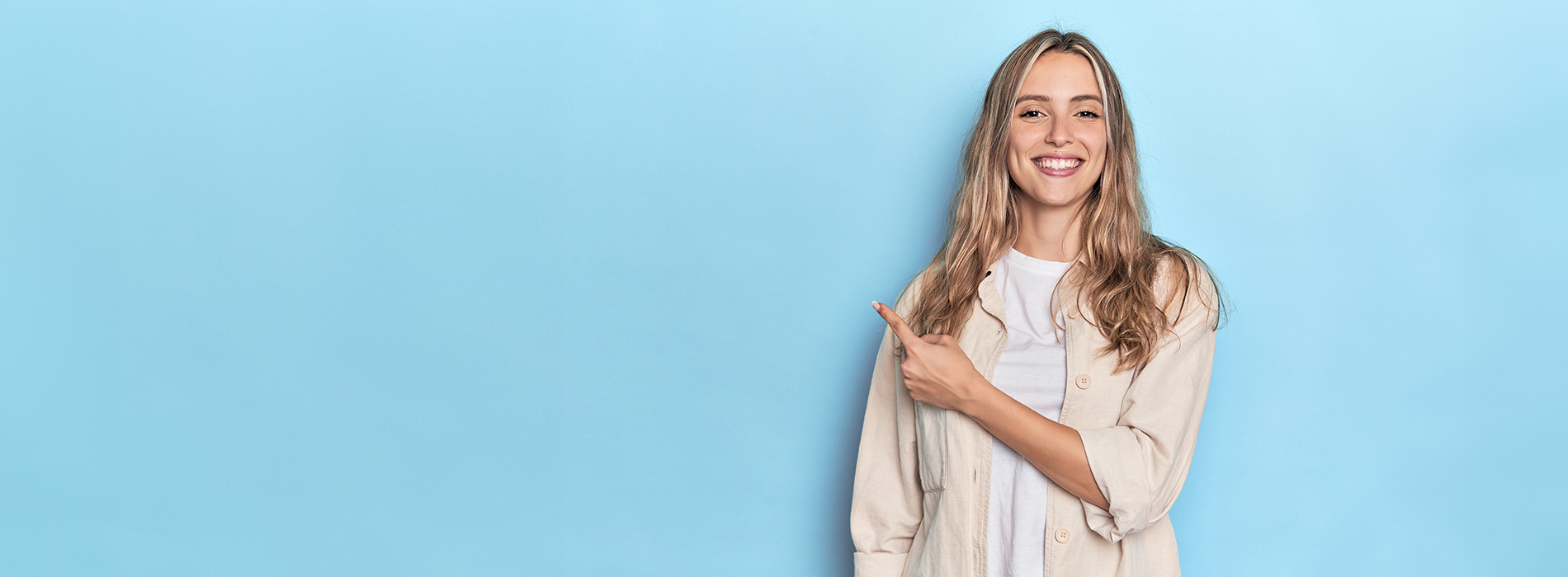 The image features a woman standing against a blue background, posing with her hand on her hip and smiling at the camera.