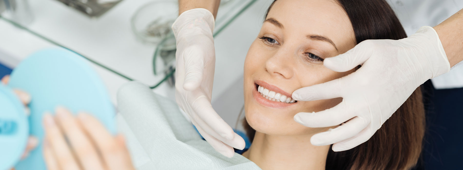 The image shows a woman receiving a facial treatment at a beauty salon, with a professional applying a mask to her face while wearing gloves, all set against a clean, clinical background.