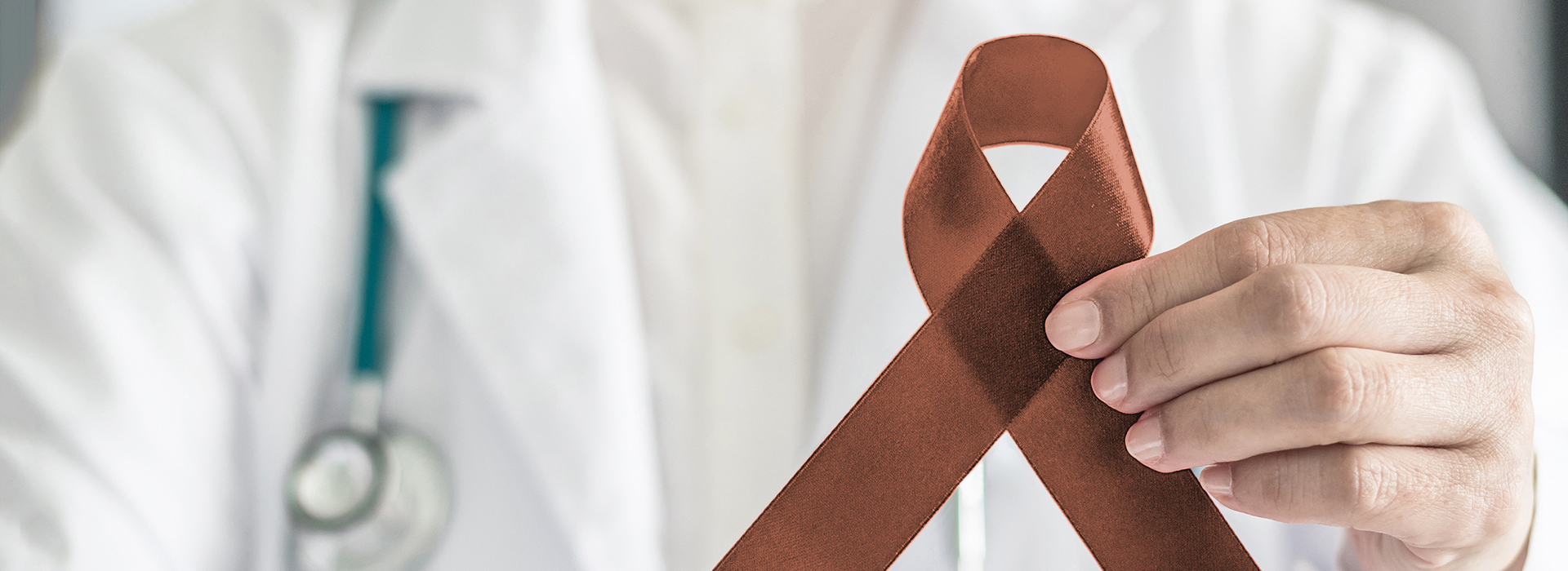 The image features a healthcare professional holding a red cross symbol, which is commonly associated with first aid and medical assistance.